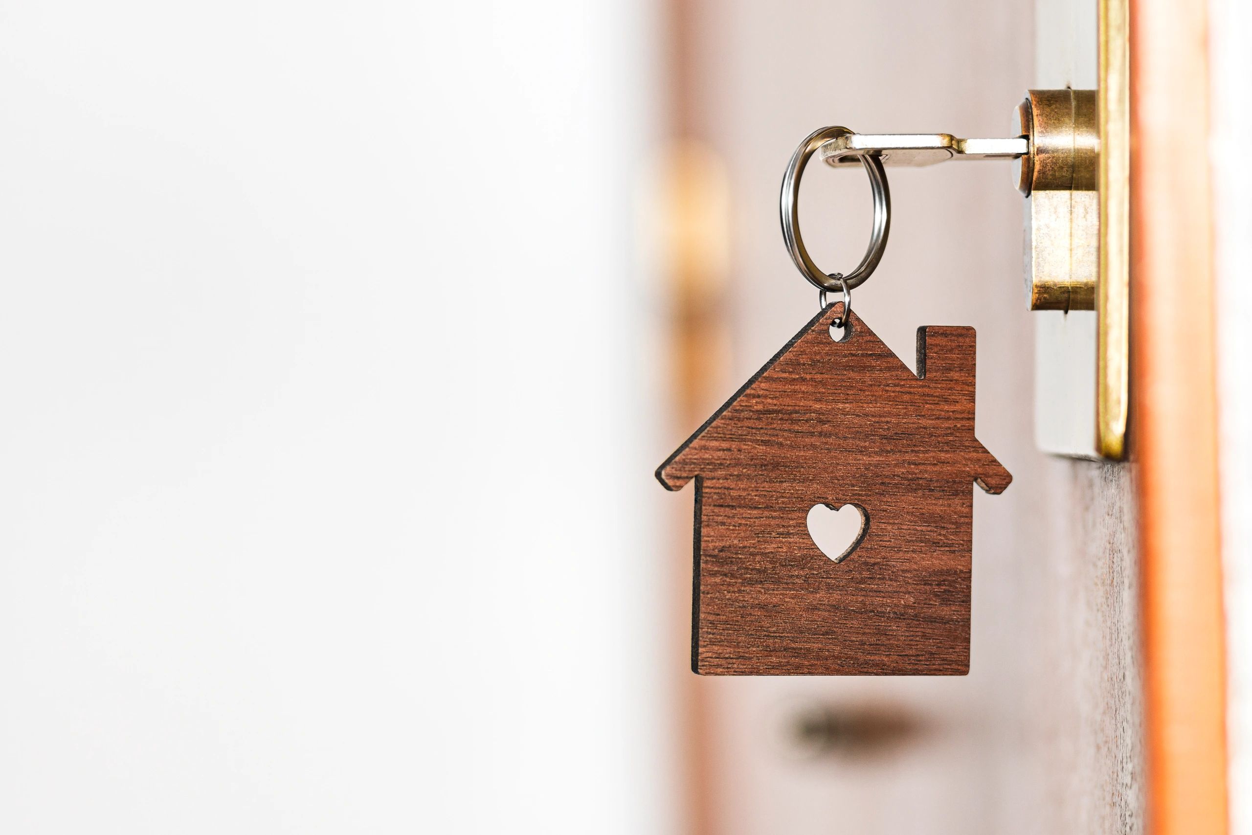 Key in a front door representing coordinated property access for maintenance